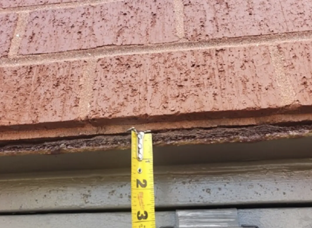 Corroded lintel causing brick cracks above window in McHenry IL