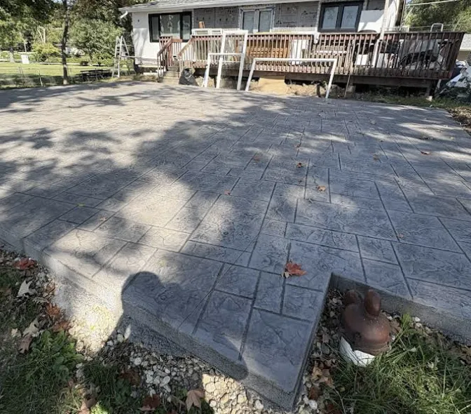 Custom stamped concrete entryway with brick border in McHenry IL