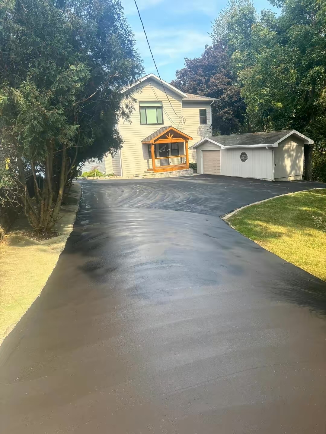 Finished asphalt driveway leading to residential home in Illinois